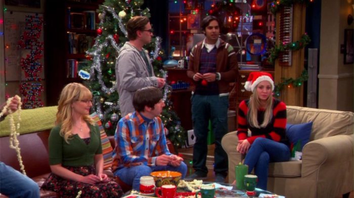 Amy, Leonard, and Penny decorating a Christmas tree while imagining a world without Sheldon Cooper.