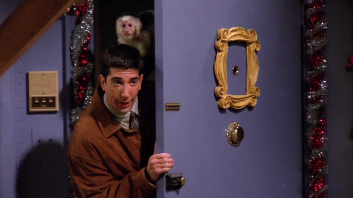 Ross Geller holding Marcel the monkey at the New Year's Eve party.