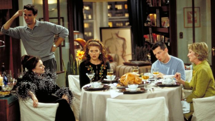 The cast of Will & Grace sitting around a Thanksgiving dinner table with a turkey, featuring Karen, Will, Grace, Jack, and Jack's mother, Judith.
