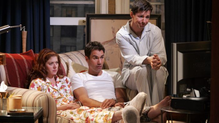 Grace, Will, and Jack sitting together in the apartment watching television in their pajamas.